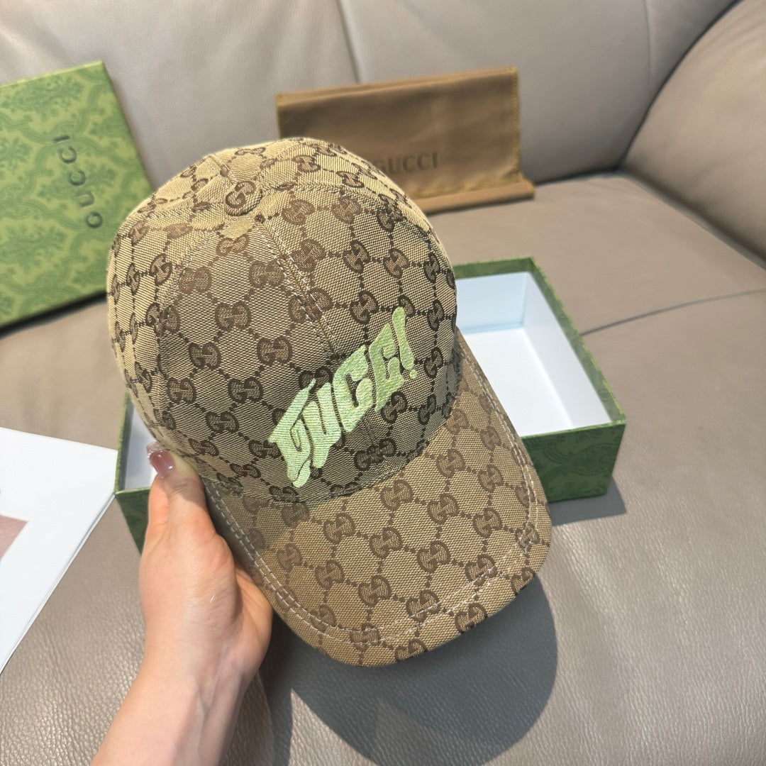 Gucci cap in tan GG monogram canvas with neon green logo, held by hand