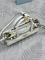 White Prada handbag on side view with shoulder strap and gold-tone clasps.
