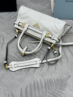 White Prada handbag with structured front strap, top handle, and detachable crossbody strap.