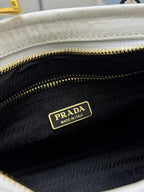 Prada handbag interior with black lining, gold zipper, and Prada 'Made in Italy' label.