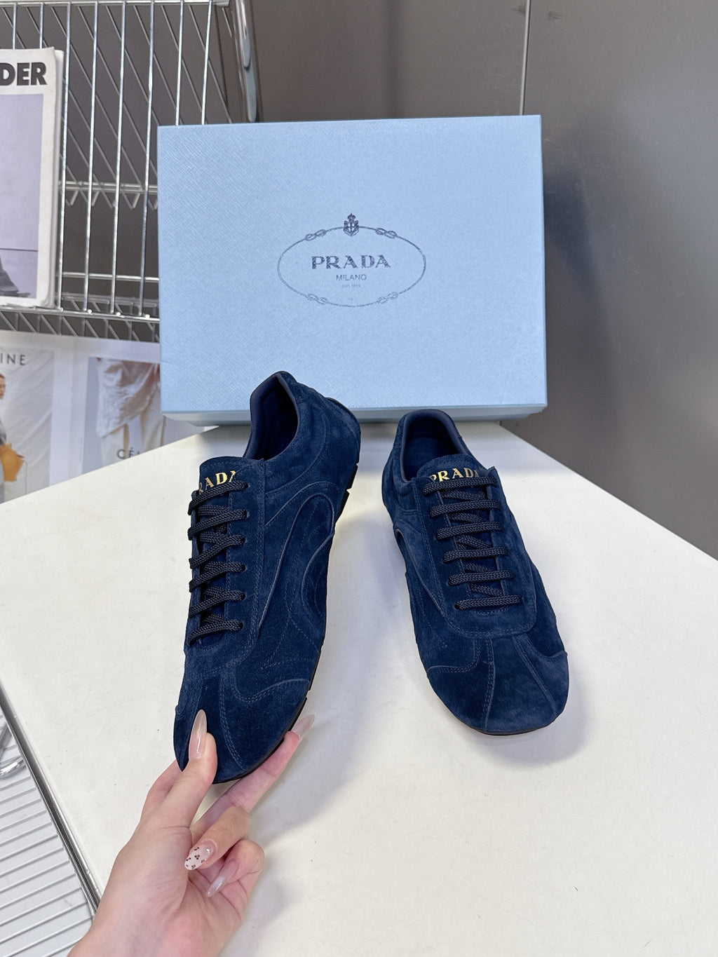Blue suede sneakers with lace-up vamp and visible heel branding.