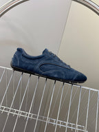 Blue suede low-top sneakers, textured side panel and lace-up front.