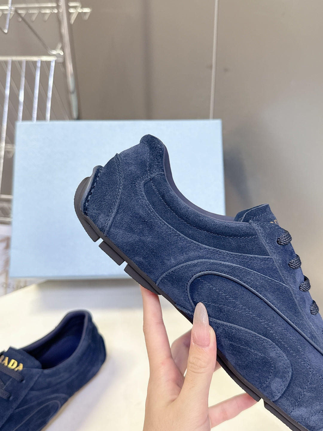 Blue suede low-top sneaker with side seam stitch and rubber sole.