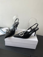 Black pointed-toe slingback pumps with silver buckle strap and stiletto heel pair