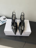 Black pointed-toe Dior slingback pumps with buckle strap and stiletto heels