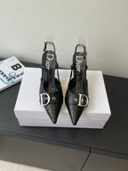 Black pointed-toe Dior slingback pumps with buckle strap and stiletto heels