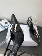 Black pointed-toe slingback pump with silver buckle strap and textured leather upper