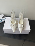 Cream leather women’s slingback heels with double buckle straps and pointed toe