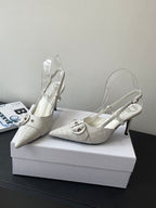 Cream leather women’s pointed-toe slingback heels with ankle strap and buckle