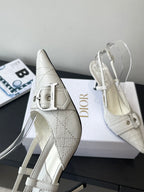 Cream leather pointed-toe slingback heels with metal buckle and high stiletto heel