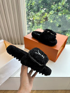 Black faux-fur slide slippers with V-logo and silver zipper hardware