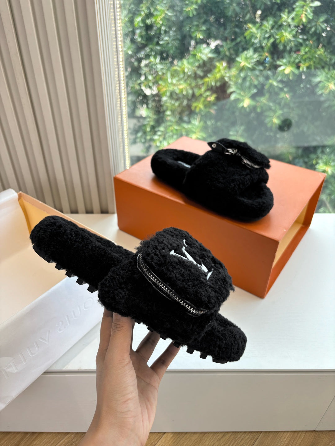 Black faux-fur slide slippers with V-logo and silver zipper hardware