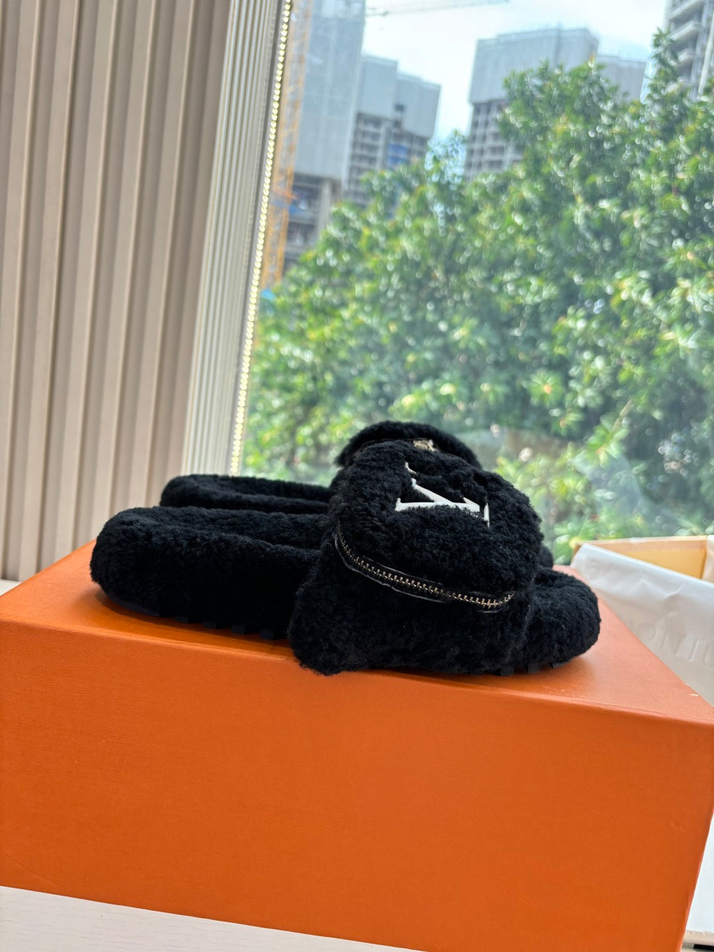 Black faux-fur slide sandals with V-logo strap detail