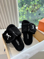 Pair of black faux-fur mules with side zipper and V-logo emblem