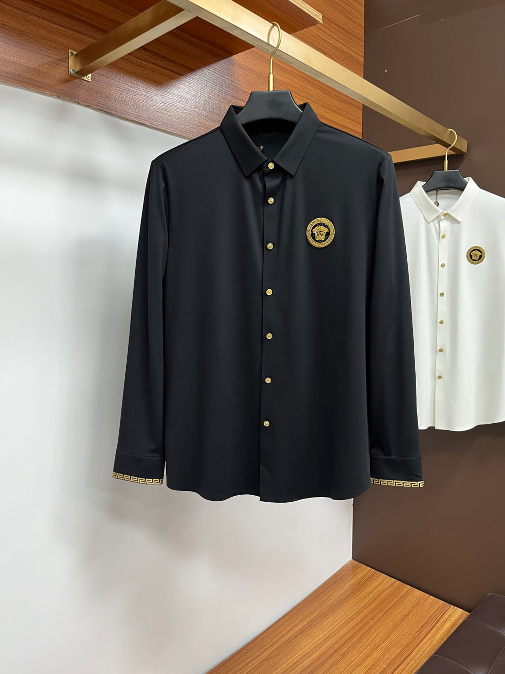 Dark navy button-up shirt with point collar, gold buttons, and gold emblem patch