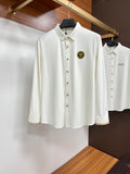 White button-up shirt with point collar, gold buttons, and Versace-style medallion patch