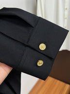 Versace black dress shirt cuff with gold button and embroidered logo
