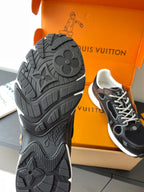 Louis Vuitton ladies sneakers outsole view, textured black tread with logo details