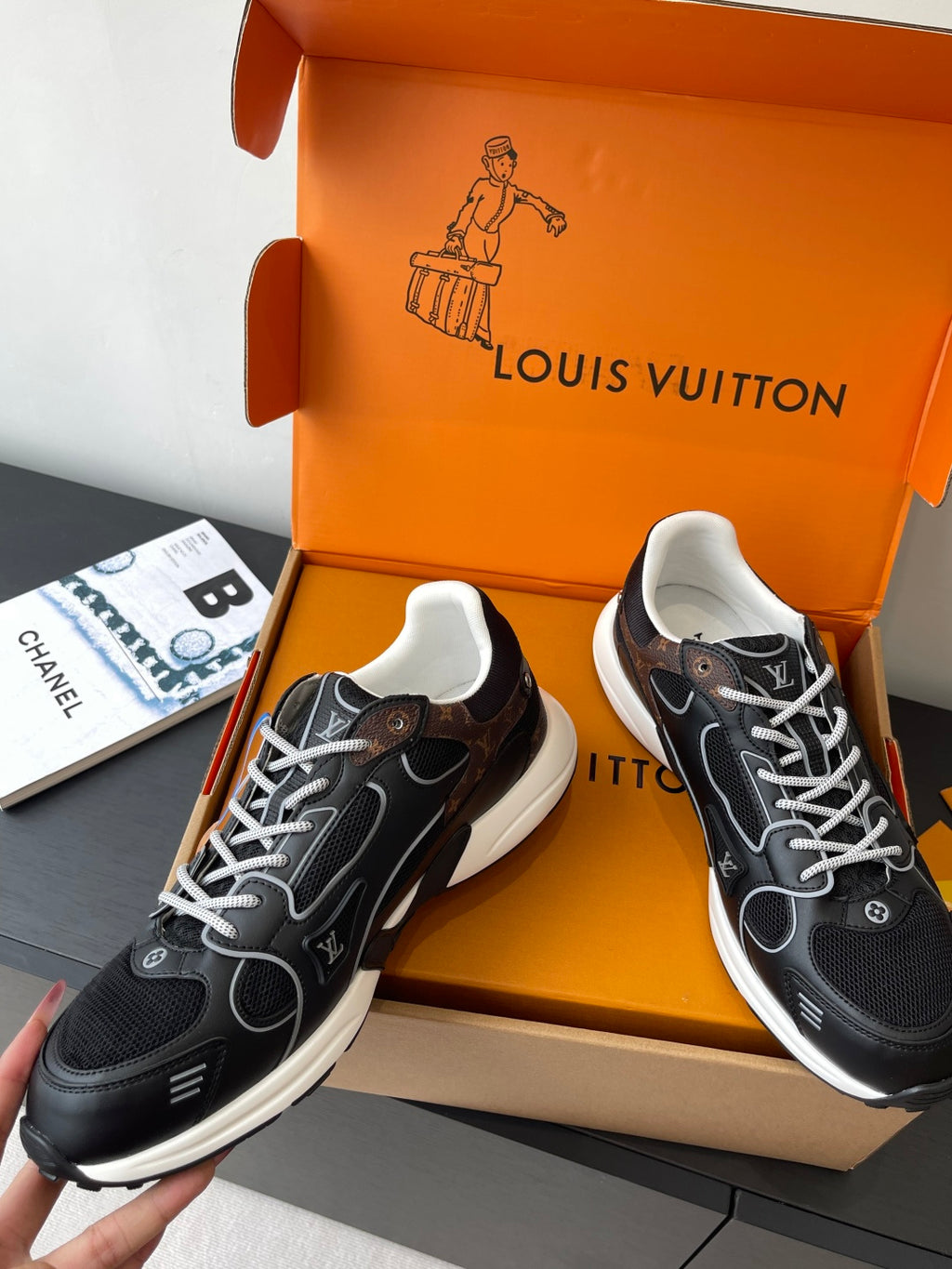 Louis Vuitton ladies sneakers pair in black with white laces and brown accent button