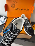 Louis Vuitton ladies sneaker close-up, black knit upper with white laces and logos
