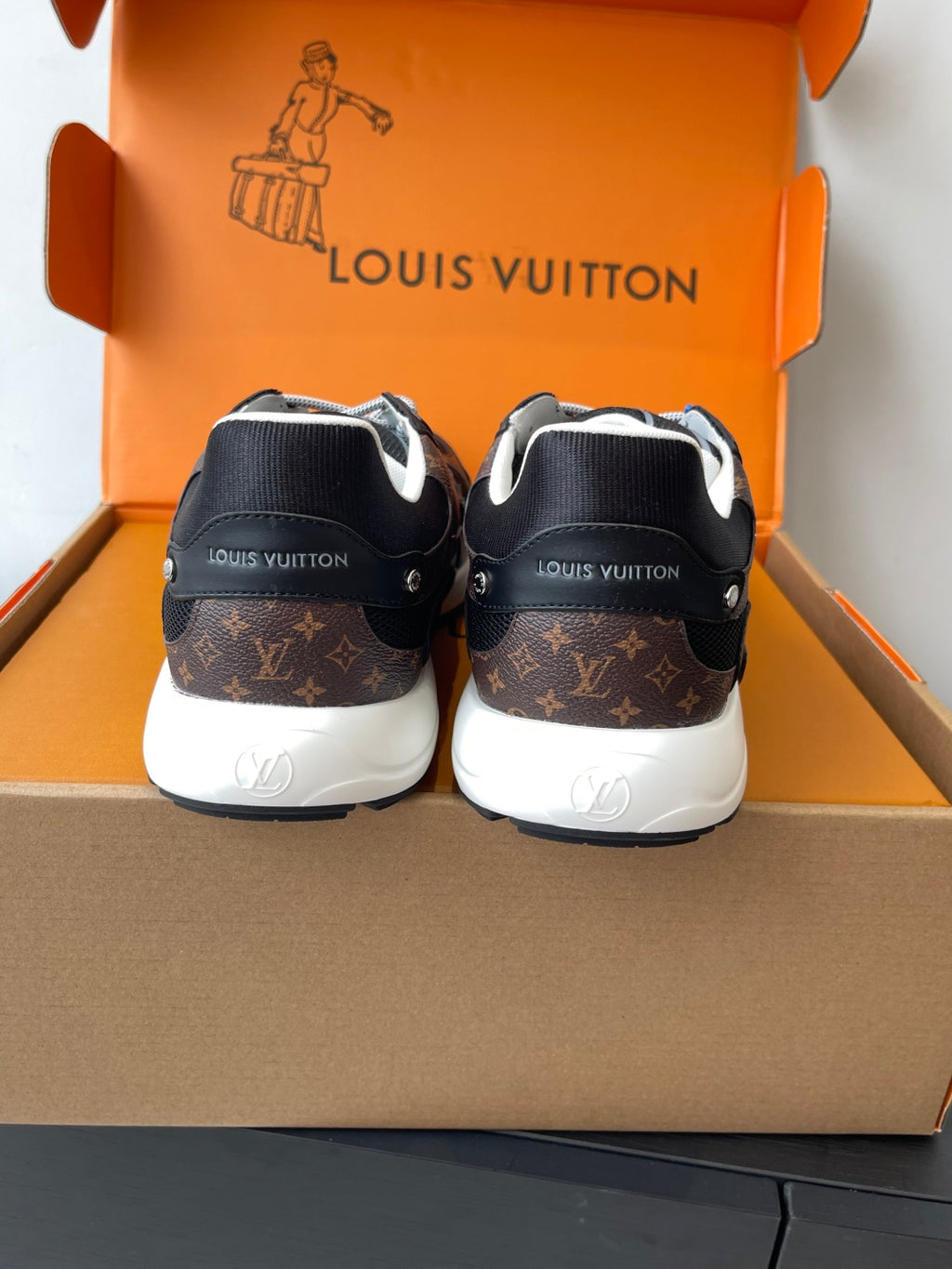 Louis Vuitton ladies sneaker back view, black with brown monogram heel panel
