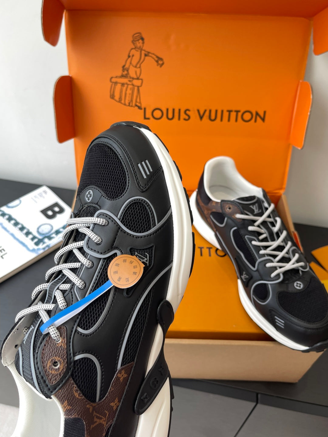Louis Vuitton ladies sneakers heel and side view, black with white soles and blue stripe