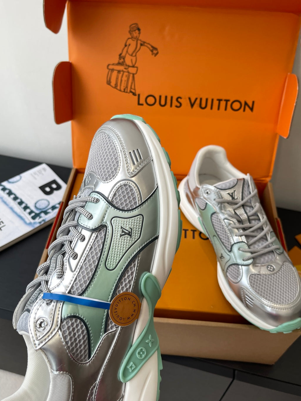 Silver mesh ladies sneakers, blue pull tab and mint sole trim in open box