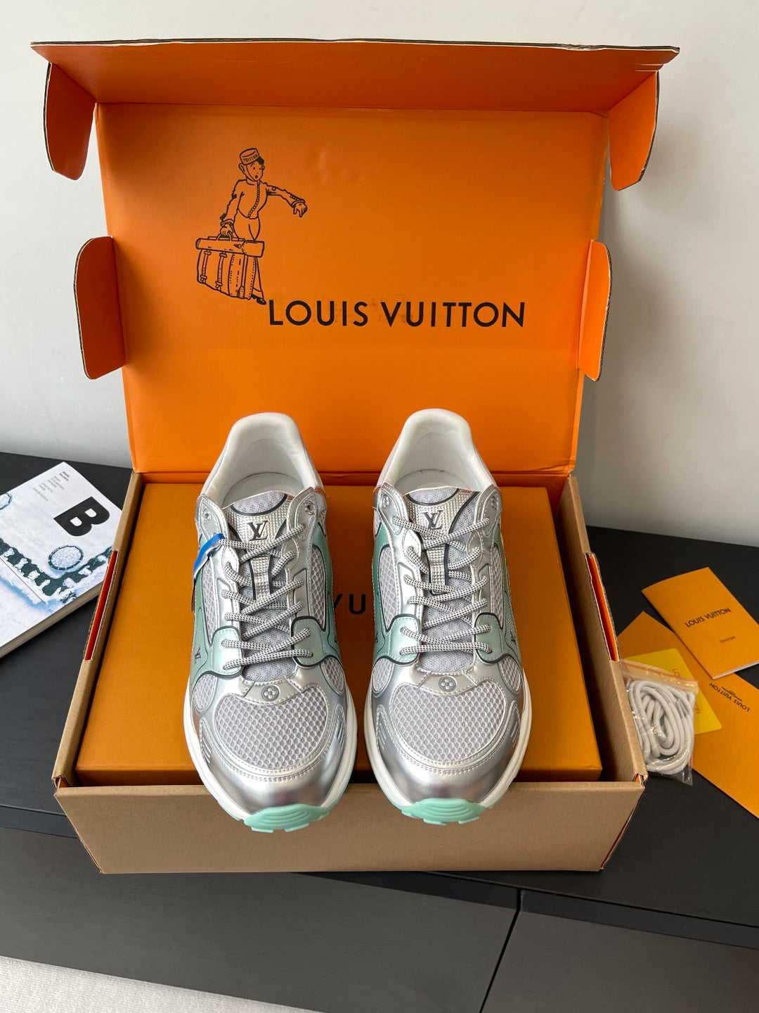 Pair of silver mesh ladies sneakers with mint trim and lace-up design