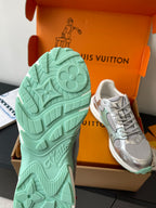 Mint green rubber outsole and tread pattern with silver sneaker next to it