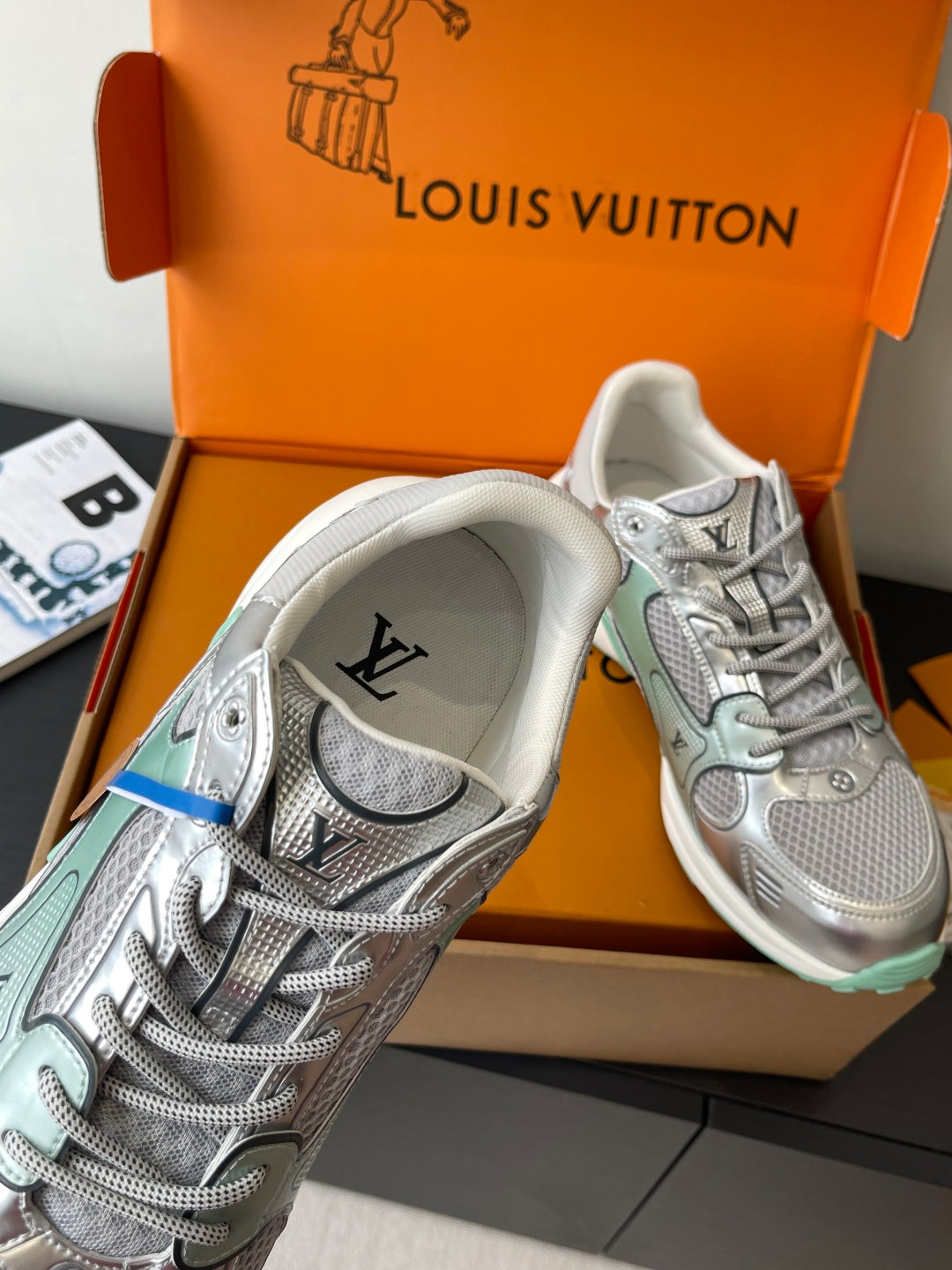 Silver mesh ladies sneaker with lace-up front, mint sole edge and brand on heel
