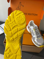 Yellow Louis Vuitton sneaker outsole with embossed logo pattern, shown beside shoe