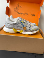Silver Louis Vuitton sneaker in box, side view with blue and yellow trim