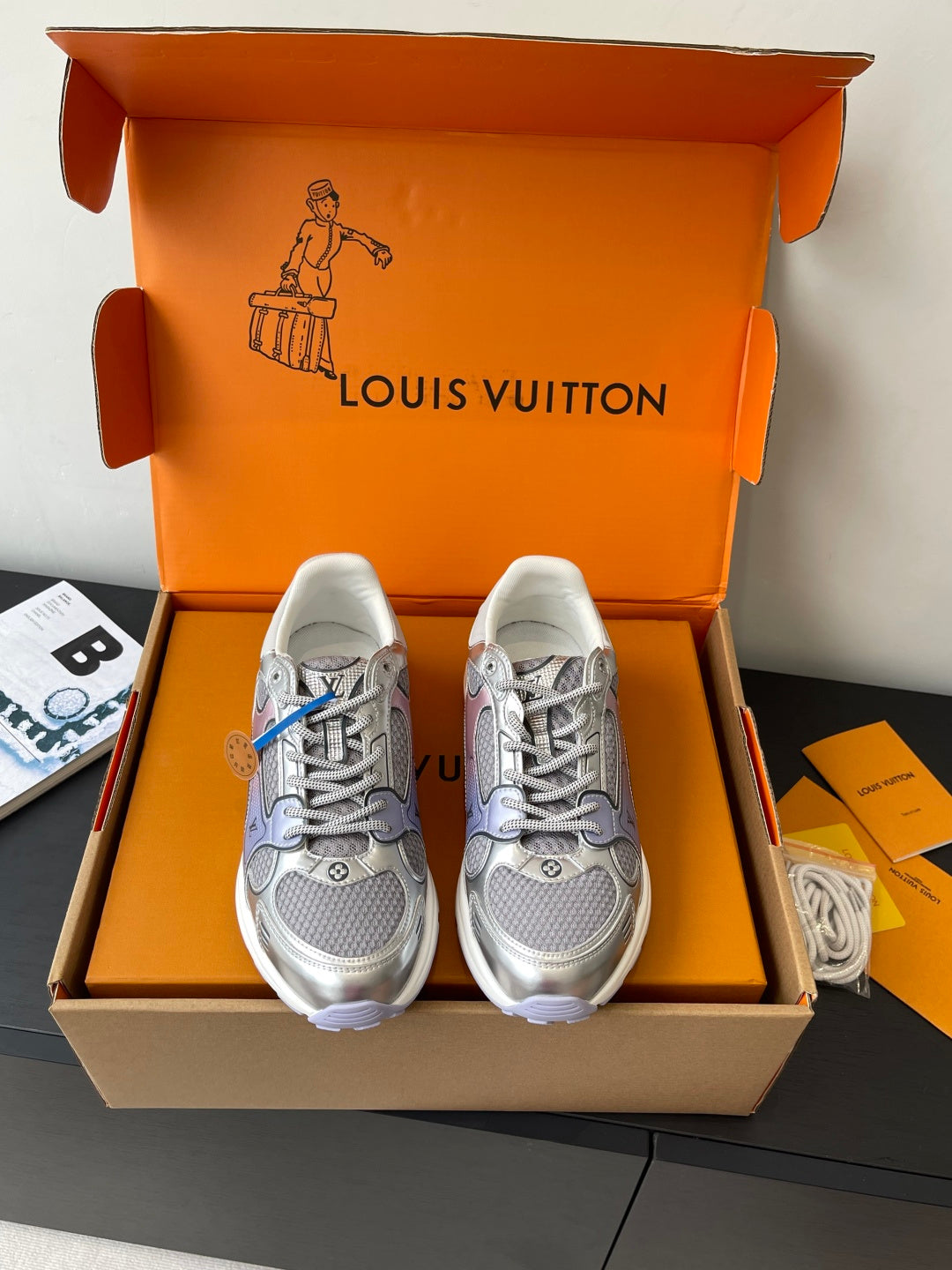 Ladies' luxury sneakers in light gray with lace-up front, inside box display