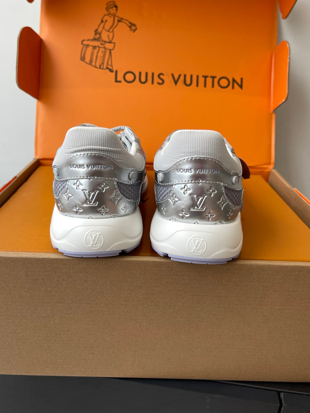 Ladies' luxury sneakers with LV-patterned heels and white soles, back view