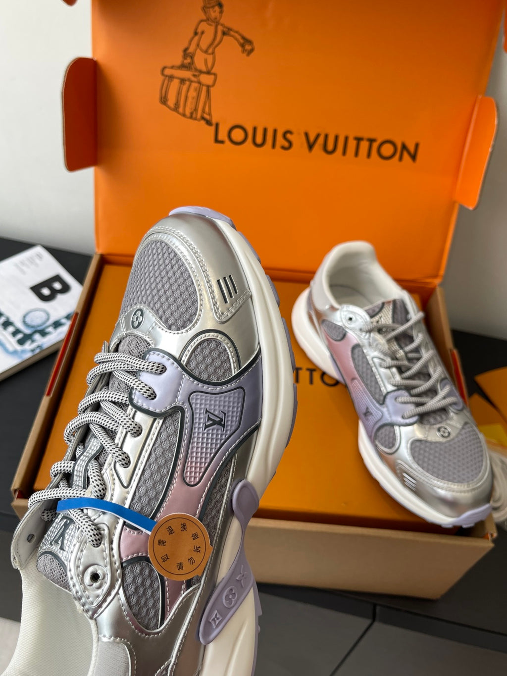 Ladies' luxury sneakers, gray uppers with pink and brown patch accents, in box