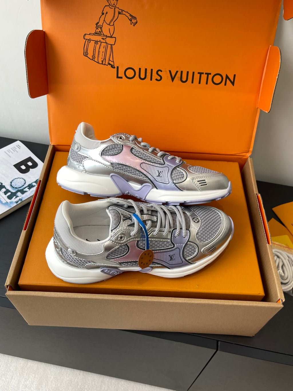 Pair of ladies' luxury sneakers, light gray with colorful patches and lace-up front
