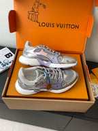 Pair of ladies' luxury sneakers, light gray with colorful patches and lace-up front