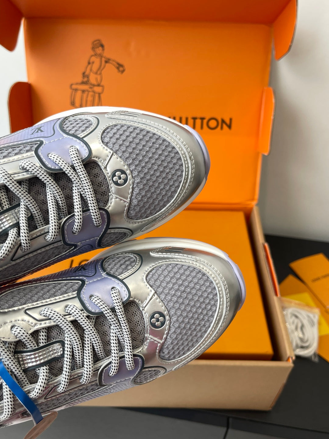 Ladies' luxury sneakers close-up of treaded outsole and lace-up sneaker upper