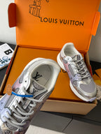 Ladies' luxury sneakers with white midsoles and gray uppers, side view in box