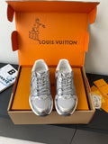 Silver Louis Vuitton-inspired ladies sneakers with lace-up front, set in gift box.