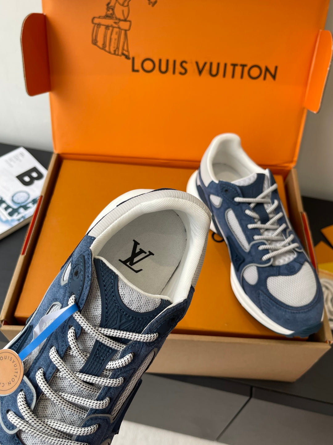 Navy and white ladies' sneakers with lace-up closure and stitched logo detail
