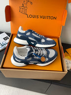 Navy and white lace-up sneakers with tan button detail and contrasting soles