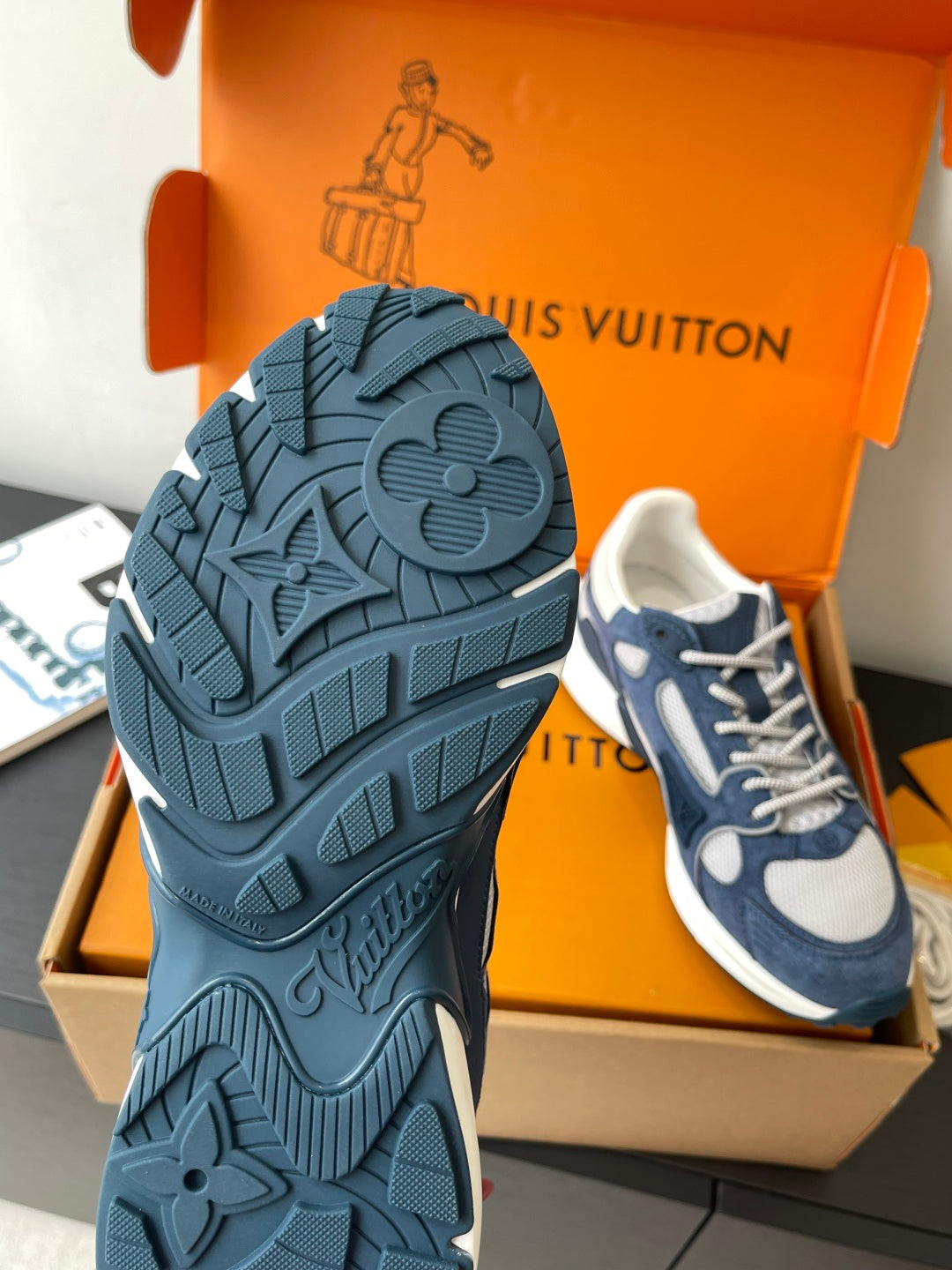 Blue sneaker outsole with molded traction pattern and raised flex grooves