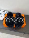 Black plush slide sandals with white monogram pattern, wide crossover straps