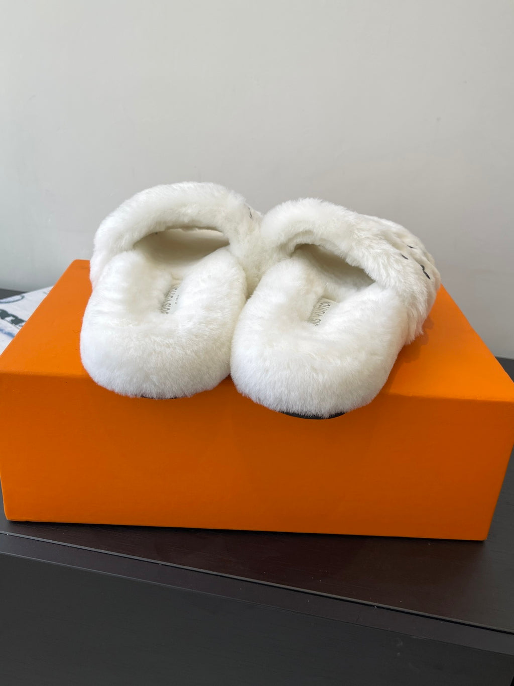 Louis Vuitton women’s plush slides, white faux-fur slip-ons with curved straps