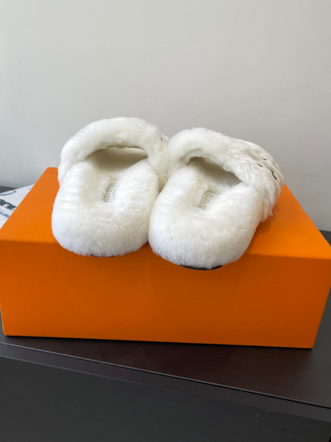Louis Vuitton women’s plush slides, white faux-fur slip-ons with curved straps