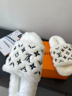 Louis Vuitton women’s plush slide sandals, close-up of white strap with LV monogram