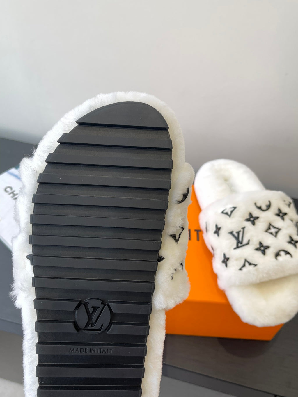 Louis Vuitton women’s plush slides, black rubber sole with LV logo
