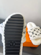 Louis Vuitton women’s plush slides, black rubber sole with LV logo