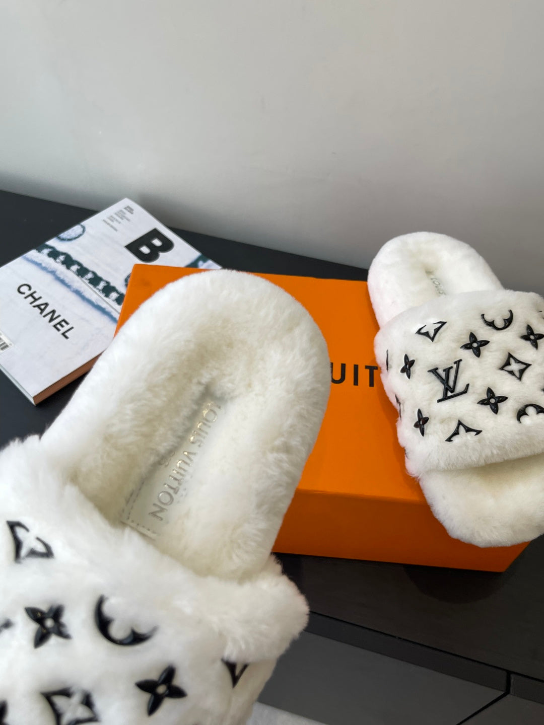 Louis Vuitton women’s plush slide sandals, white faux-fur straps with LV monogram